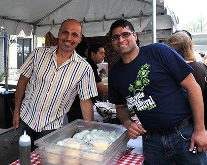 Aakash Thakkar was instrumental in bringing Busboys and Poets to Arts District Hyattsville. He is pictured here, to the right of Andy Shallal, founder of Busboys and Poets.