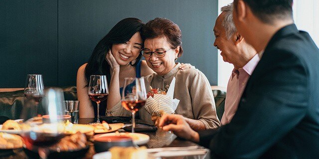 asian family dining laughing