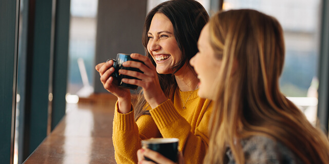 EYA-HR-AbouttheArea-Two-Young-Women-at-Coffee-Shop