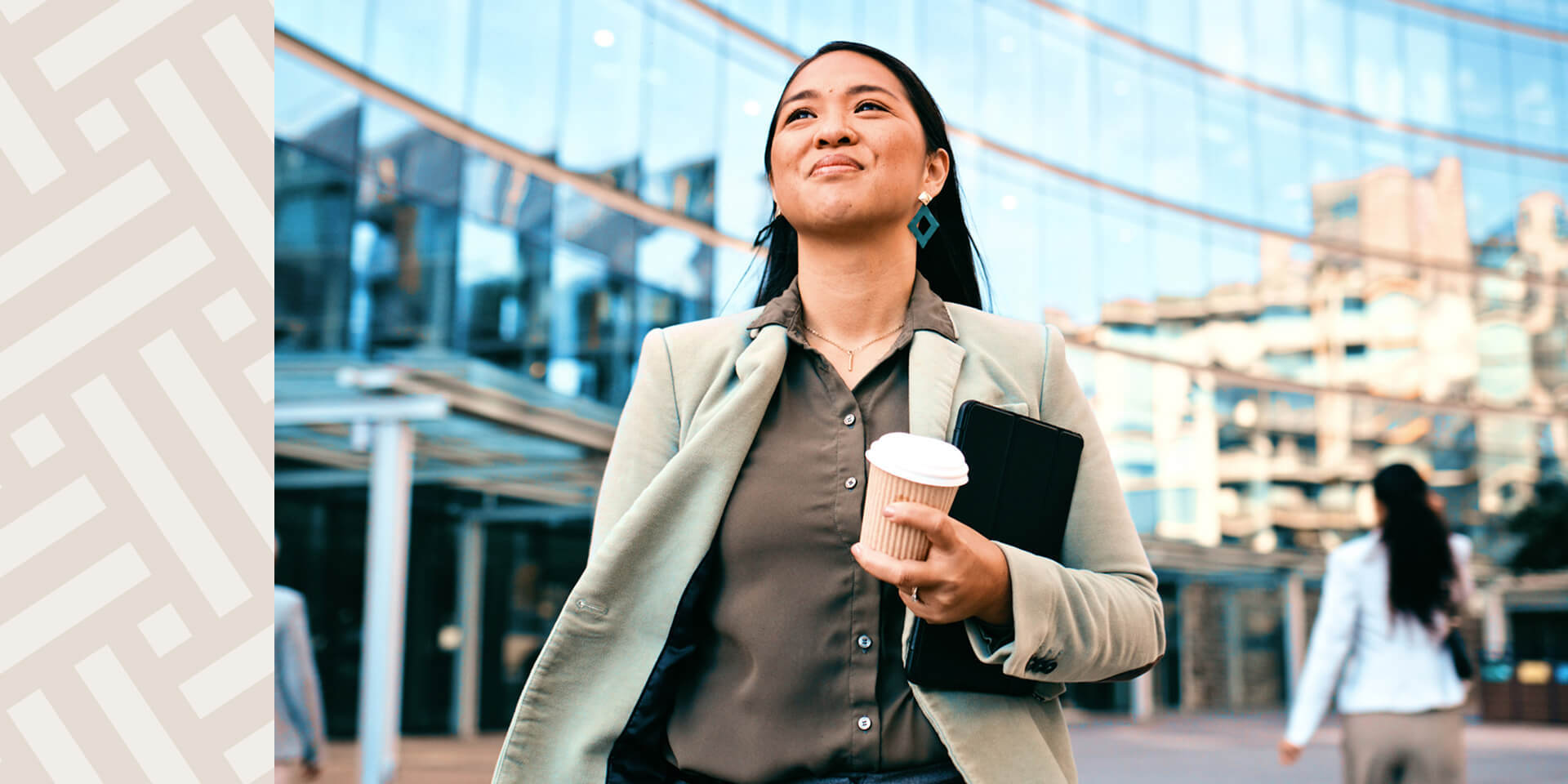 EYA-HR-MeettheTeam-Young-Businesswoman-with-Coffee-Cup-and-High-rise-Bckgrnd