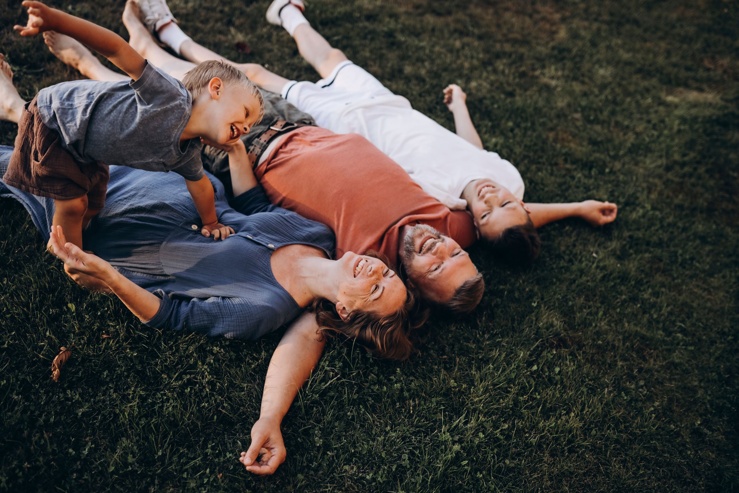 EYA_BH-Carefree-Family-Lying-in-Grass-RGB-1