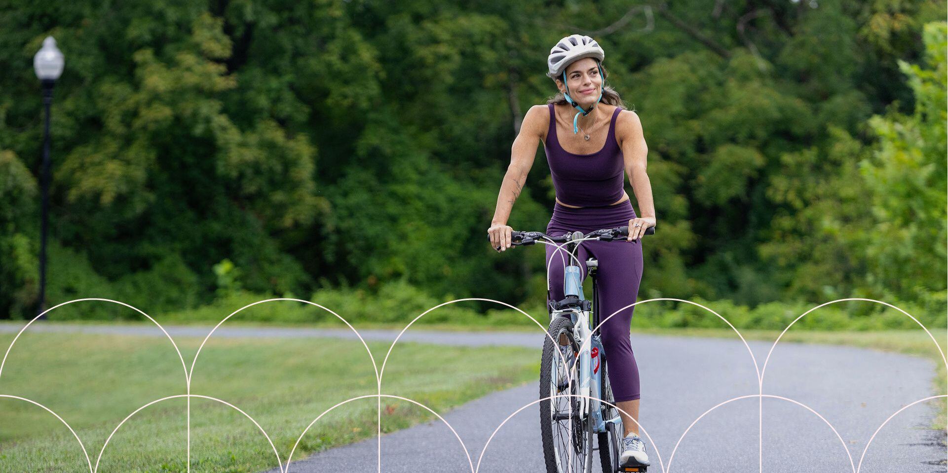 woman riding bike on path behind strathmore music hall