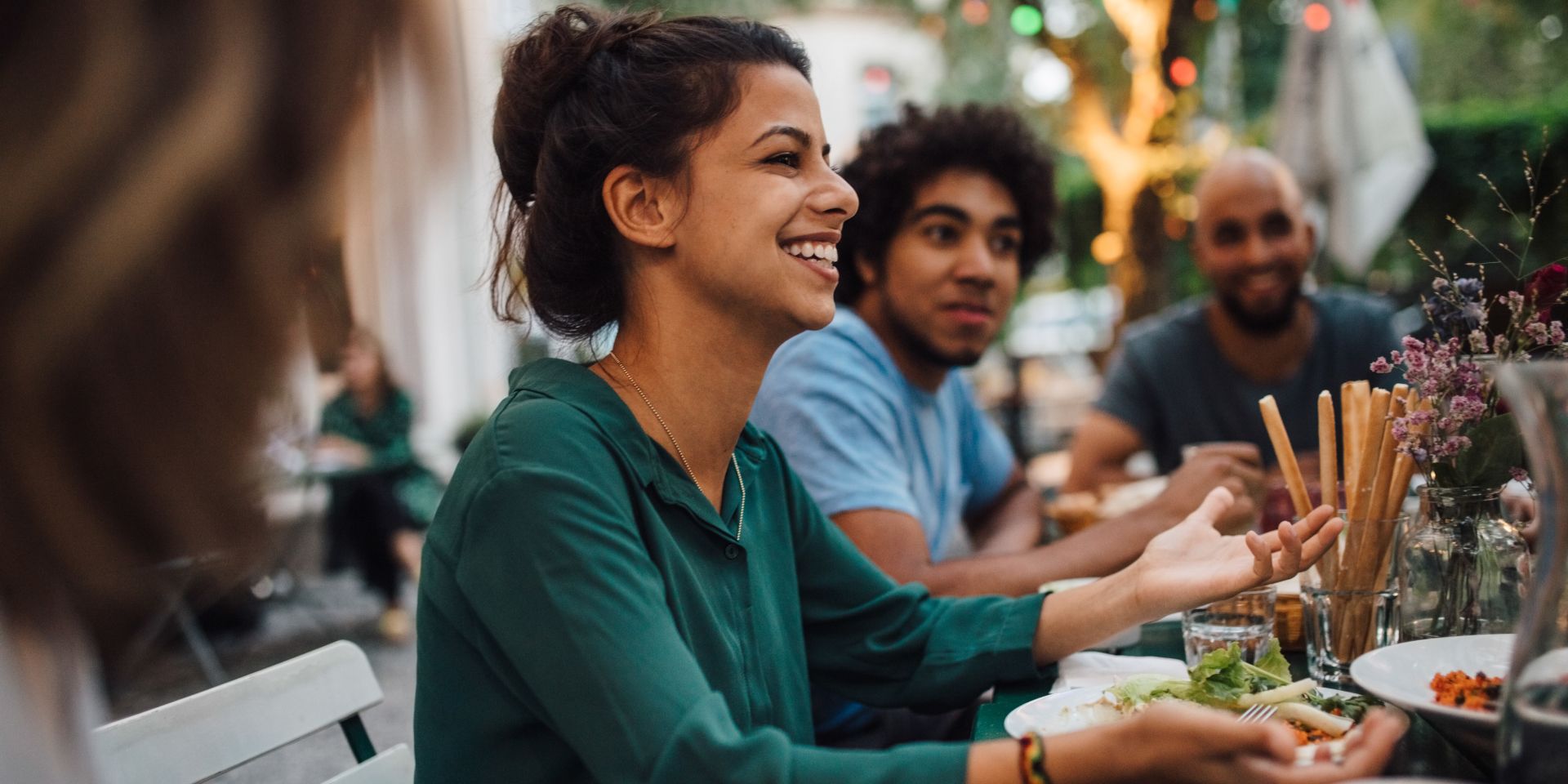 cta footer - WS_young_woman_smiling-at_dinner_party_on_restaurant_patio