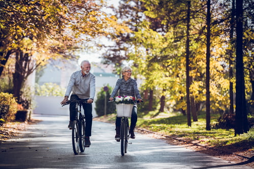 Couple bike riding in the fall